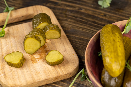 cut cucumbers marinated with salt and spices, pickled cucumbers during cooking closeupの写真素材
