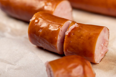 thin pork sausage fried in oil, meat sausages on food paperの写真素材