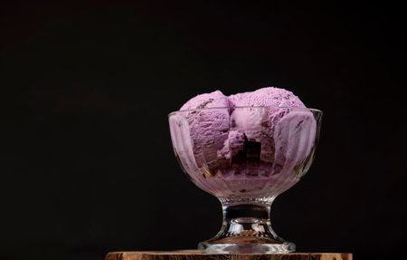 cold purple ice cream with blueberry flavor, blueberry ice cream balls in glass, side viewの写真素材