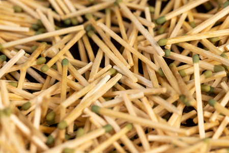 a large number of thin wooden matches with a head, close upの写真素材