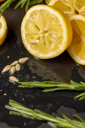 lemon on a black slate board, freshly sliced lemon on a black board, closeupの写真素材