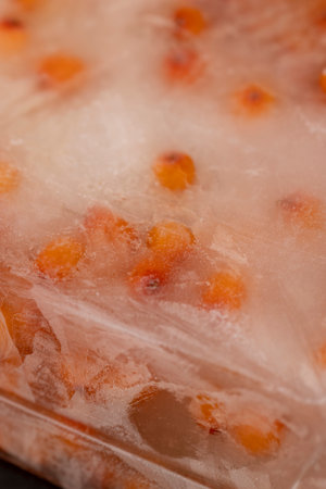 frozen orange sea buckthorn berries, orange sea buckthorn berries during deep freezing, close upの写真素材