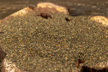 dried tea leaves, ground and crumbled into very small pieces with the addition of flavoring and aromatic additives, tea leaf powder, close upの写真素材