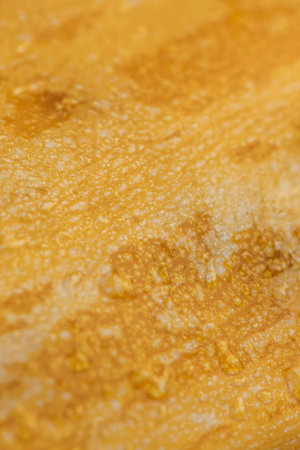natural yellow-orange peel of a ripe pumpkin, close up