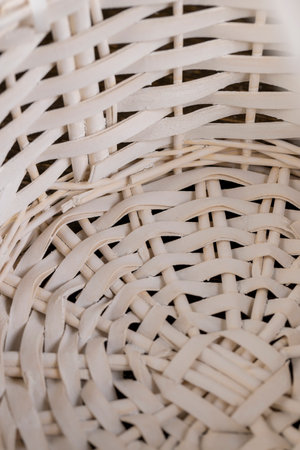 a white wicker basket for food, natural branches painted white from which a decorative basket is woven close upの写真素材