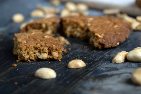 oatmeal cookies with peanuts on a black wooden table, homemade oatmeal cookies with peanut nuts