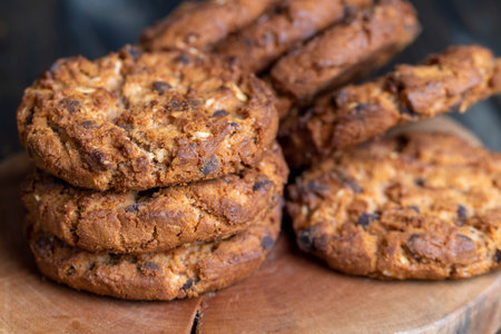 Delicious cookies with pieces of chocolate on the table, crispy and fresh oatmeal cookies with...
