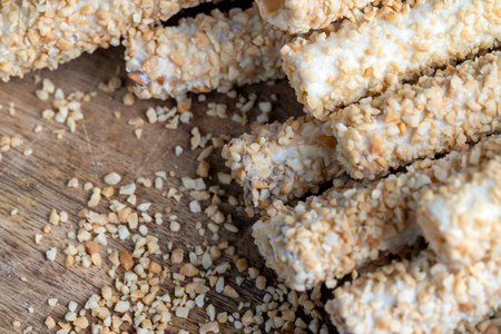 waffle tube with chocolate filling and crushed peanuts, sweet waffle tubes with fried pieces of peanuts with chocolate fillingの写真素材