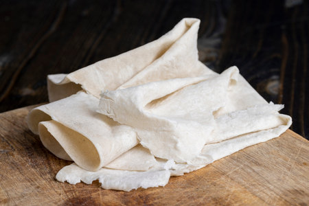 Fresh and soft wheat lavash on a board, Armenian lavash is stacked on a board during cooking