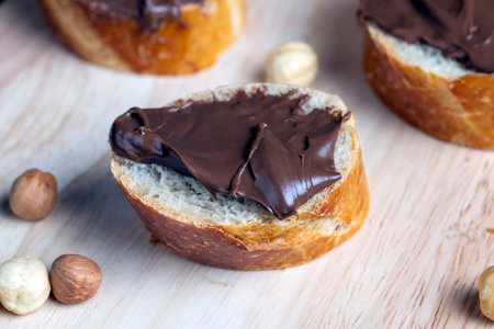chocolate butter spread on a baguette, sweet chocolate butter spread on a baguette during the...