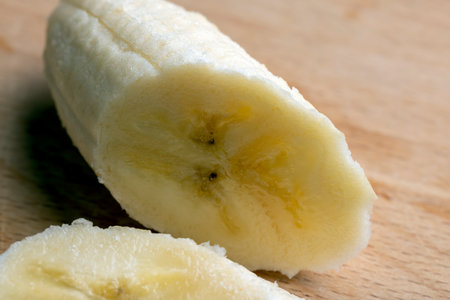 Sliced pieces of ripe yellow banana, ripe yellow banana during splitの写真素材