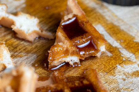 square sweet soft waffles in bee honey , a traditional European dessert of soft waffles in sweet honeyの写真素材