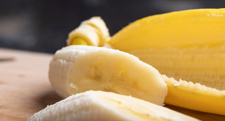 Sliced pieces of ripe yellow banana, ripe yellow banana during splitの写真素材