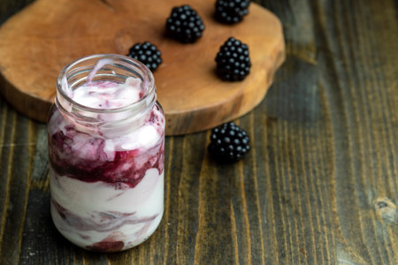 Fresh delicious milk yogurt with blackberry flavor, yogurt with fresh berries and blackberry jamの写真素材