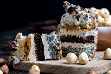 multi-layer cake with different layers, caramel, poppy seeds and cream layers of cake for dessert with nutsの写真素材