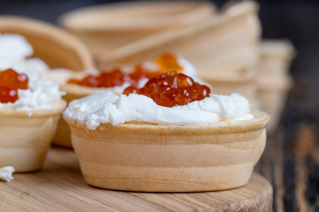 Cooking a dish with waffles and cottage cheese cream with caviar, red salmon caviar during cookingの写真素材