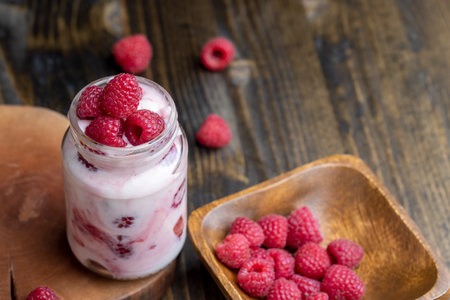 Milk yogurt with raspberries, layered yogurt with raspberry flavor and fresh berriesの写真素材