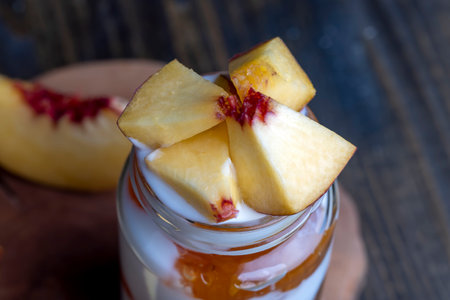 Yogurt made from fresh milk with the addition of sweet peach jam and fresh peaches, delicious yogurt with peach flavorの写真素材