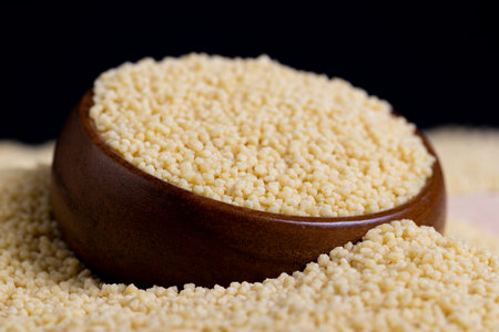 Fresh raw porridge couscous from wheat or millet, cooking dishes from traditional cereals of crushed...