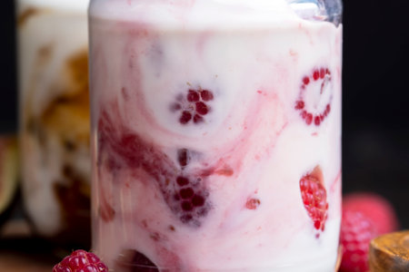 Milk yogurt with raspberries, layered yogurt with raspberry flavor and fresh berriesの写真素材