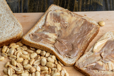Peanut paste with chocolate paste on white bread, making sandwiches from mixed chocolate peanut...