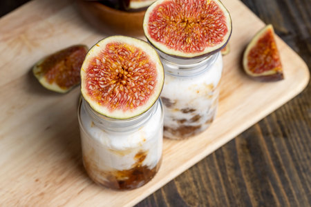 Yogurt made from fresh milk with the addition of sweet jam from figs with pieces of fruit, delicious yogurt with the taste of figsの写真素材