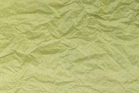 crumpled thin soft paper for packaging or other purposes, part of a sheet of paper crumpled after useの写真素材