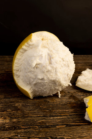 one large citrus on a black table and on a black background, ripe citrus fruit, close upの写真素材