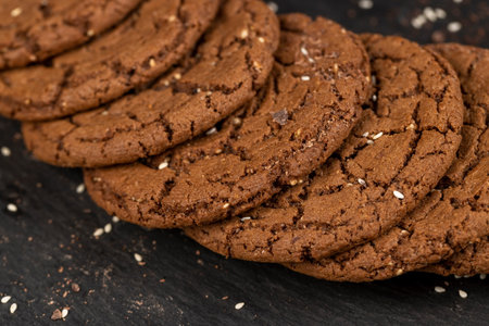 round chocolate biscuits with white sesame seeds and cocoa powder, sweet chocolate-flavored biscuits...