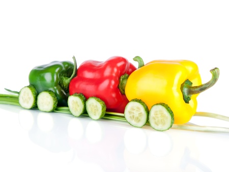 Train made of various sweet pepper vegetables and cucumbers isolated on white backgroundの写真素材