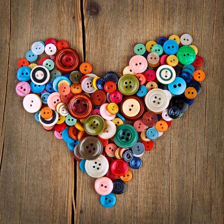 Colorful buttons heart on wooden backgroundの写真素材