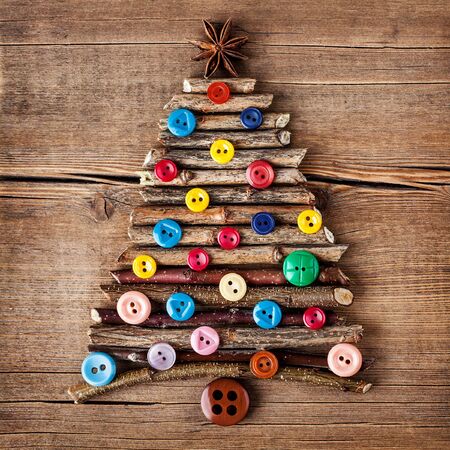Christmas card with natural decorations on wooden background. Set of different varieties of objects in the form of a tree.の写真素材