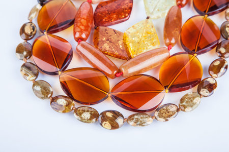 Lot of yellow beads from different minerals and stone backgroundの写真素材