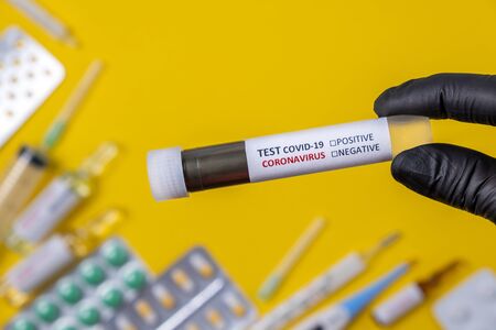 COVID-19 test. Nurse holding in hand test tube with laboratory sample of blood for 2019-nCoV Corona virus testing diagnosis analyzing, Concept.の写真素材