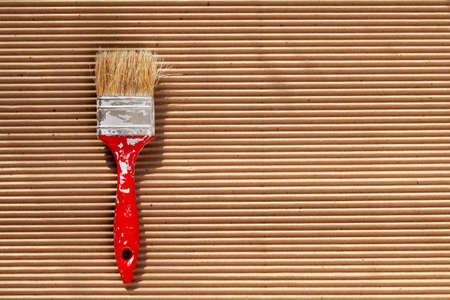 Old paint brush with colorful paint. Painting tools and accessories for home renovation. Paintbrush copy spaceの写真素材