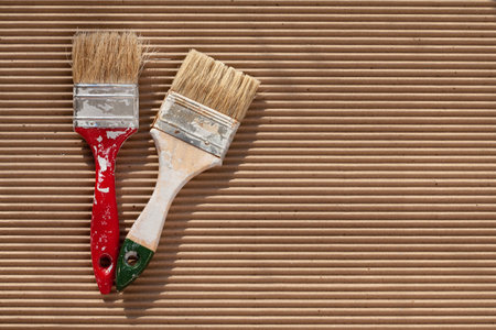 Old paint brush with colorful paint. Painting tools and accessories for home renovation. Paintbrush copy spaceの写真素材