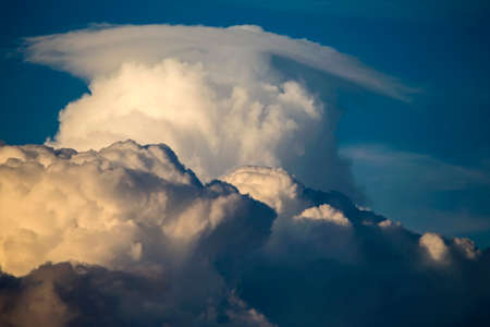 Cumulus clouds in the sunset light. Abstract composition of dramatic sky.の写真素材