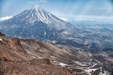 Mountains and volcanoes. Beautiful landscape of Kamchatka Peninsula: summer panoramic view of Mountain Range Vachkazhets, mountain lake and clouds in blue sky on sunny day. Eurasia, Russian Far East, Kamchatka Region.の写真素材