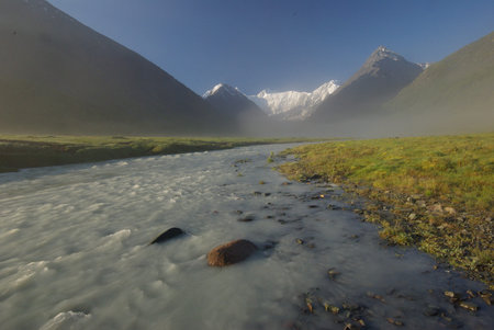 The mountain river in the mountains. Current through the gorge the river. Stones and rocky land near the river. Beautiful mountain landscape.の写真素材