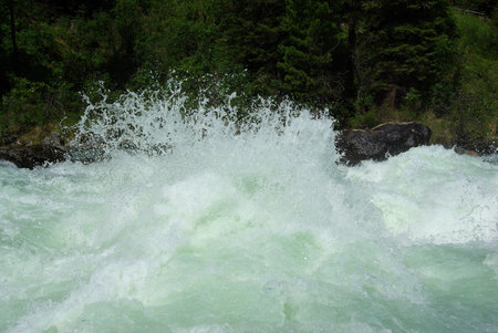 The mountain river in the mountains. Current through the gorge the river. Stones and rocky land near the river. Beautiful mountain landscape.の写真素材
