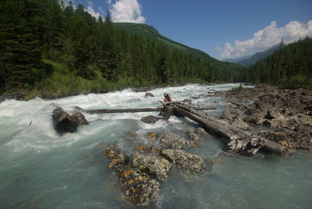 The mountain river in the mountains. Current through the gorge the river. Stones and rocky land near...