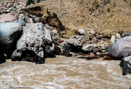 A mountain river, a rushing stream of water in the mountains.