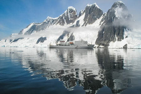 The landscape of the coast of Antarctica, Mountains covered with snow and ice-cold ocean.の写真素材