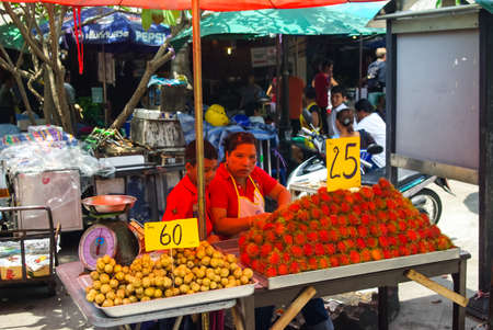 Bangkok, Thailand - August 24, 2018: Shop on the market in Bangkok, people sell fruit and seafood.のeditorial素材