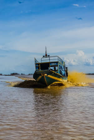 Phuket, Thailand - July 23, 2014: boat sailing on the dirty water of the river in Thailand.のeditorial素材