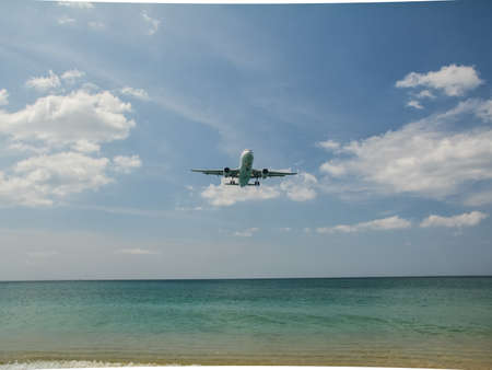 The plane flies over the sea to land at the airport. The plane flies over the sea to land at the airport.の写真素材