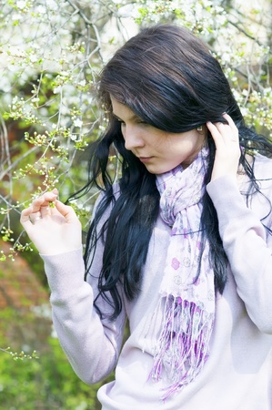 Beautiful girl in a flowering gardenの写真素材
