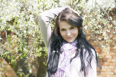 Beautiful girl in a flowering gardenの写真素材
