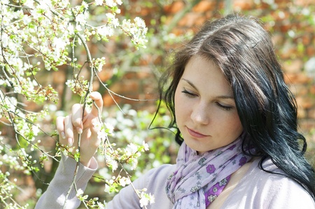Beautiful girl in a flowering gardenの写真素材