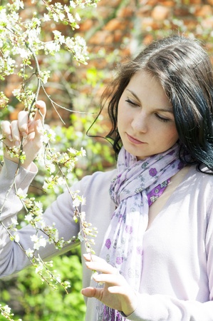 Beautiful girl in a flowering gardenの写真素材